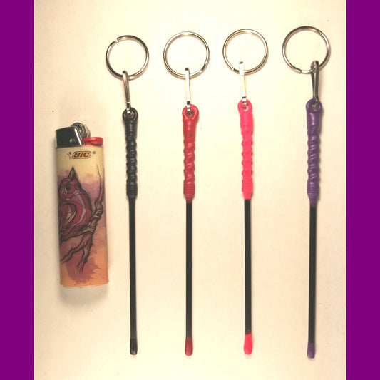  keychains, rods, and a lighter on a white background